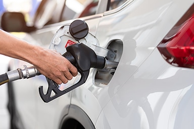 Hand refilling the car with fuel, close-up, Pumping equipment gas at gas station.